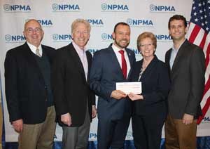 The NPMA's Dr. Jim Fredericks receives the NPMA Foundation check from Copesan President Deni Naumann. From left are Dr. Jim Sargent, Copesan; Alfie Treleven, Sprague Pest Solutions; Fredericks, Naumann, and Dr. Bennett Jordan, Copesan.