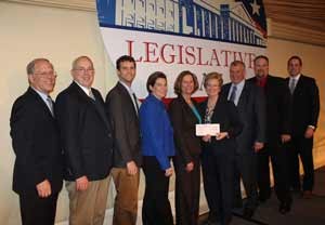 Dini Naumann presents the Pi Chi Omega check to Judy Black. From left are Russ Ives, Rose Pest Solutions; Dr. Jim Sargent, Copesan; Dr. Bennett Jordan, Copesan; Kim Kelley-Tunis, Rollins; Judy Black, Steritech; Deni Naumann, Copesan; Bryan Cooksey, McCall Service; Dave Ramsey, Copesan; and Aric Schroeder, Copesan.