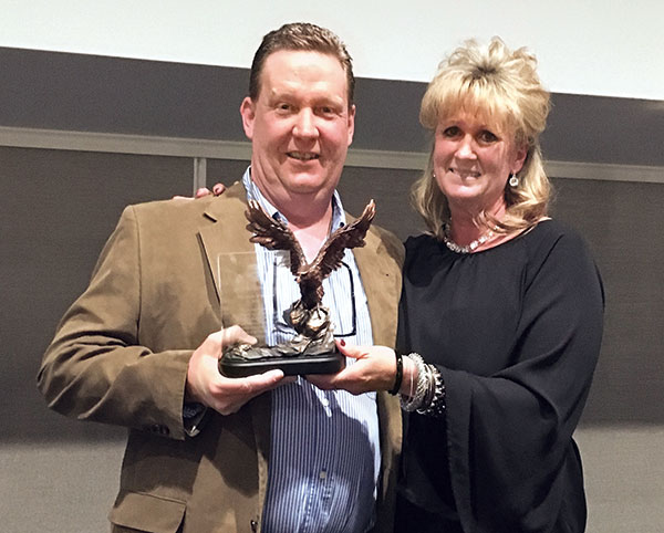 NWCOA Secretary Vikki Rawe, CWCP, Tri-State Wildlife Management, presents a Volunteer of the Year award to NWCOA General Organizer Charles Holt, CWCP, Advantage Wildlife Removal, New Richmond, Ohio. 