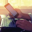 Morning work on laptop with phone in hand. Photo: ©iStock.com/jakkapan21