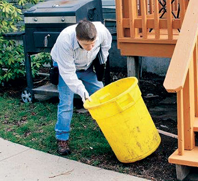 Laura Dykes takes the time to inspect for places where mosquitoes may develop. Photos: Cooper Pest Solutions