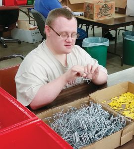 A hard-working Kness employee assembles traps. Photo: Kness Mfg. Co.