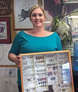 Molly Patton Marsh, who is due with her second child in November, shows one of several insect identification drawers on hand at Patton Pest Control’s headquarters. Photo: Heather Gooch