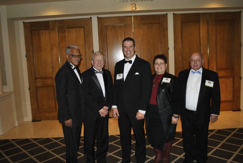 The PMP Hall of Fame induction ceremony for the Class of 2016 included, from left to right, Dr. Vernard Lewis; Larry Treleven; Blair and Brenna Toblan, who accepted the honor on behalf of their father, the late Vern Toblan; and Dick Sameth. Photo: PMP