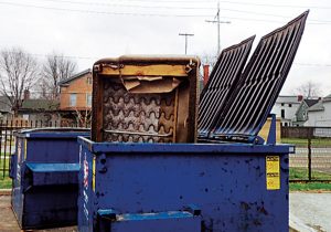 Visible furniture in the dumpster often doesn’t remain there. Photo: Mark Sheperdigian 