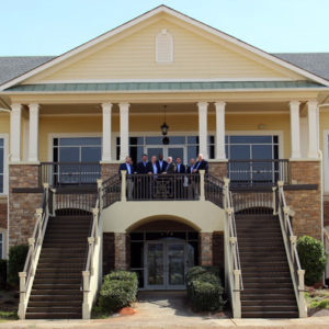 Active’s leadership team stands on the balcony of the new headquarters. PHOTO: ACTIVE PEST CONTROL