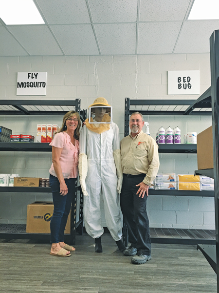 Office Manager Laura Lentz and Supervisor George Cochran stand with a Schopen Pest Solutions retail display. PHOTO: PETE SCHOPEN