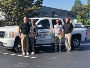 From left are Dayton and Sheila Hylton, Waynes President Eric Frye, and Shawn Hollis of Waynes. PHOTO: WAYNES PEST CONTROL 