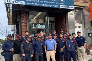 Some of the Colony Pest Management team wearing pink-trimmed hats for breast cancer awareness outside of the Brooklyn, New York, office. PHOTO: COLONY PEST MANAGEMENT