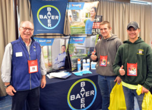 Kevin Connally, Northeast Area Sales Manager with Bayer, stands with New York Pest Expo attendees. PHOTO: MARTY WHITFORD