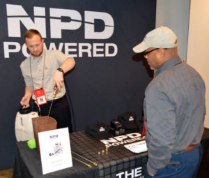 Preston Carruthers, Sales Representative with NPD Products Ltd., talks about the latest products with a New York Pest Expo attendee. PHOTO: MARTY WHITFORD