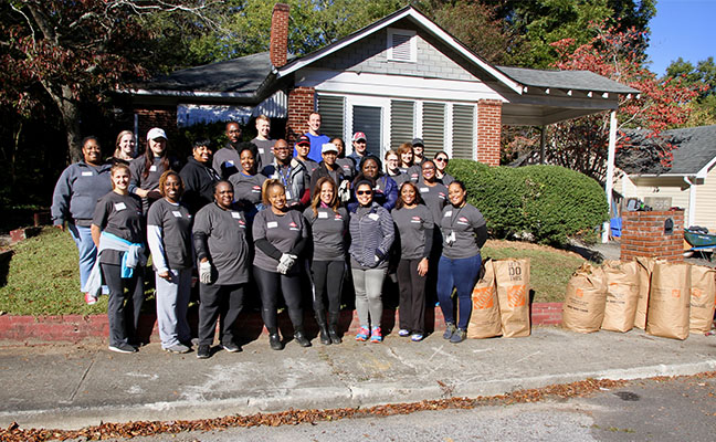 Rollins employees gather for a picture in the Grove Park community after completing their day of service. PHOTO: ROLLINS INC.