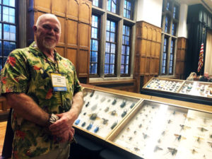 Dave Capps, Capps Pinned Insect Company, stands alongside cases of his personal insect collection at the Purdue Pest Management Conference. PHOTO: HEATHER GOOCH