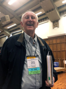 Dr. Gary Bennet stands proudly as an attendee at the Purdue Pest Management Conference for the first time in decades with his badge that jokingly reads "Retired Don't Bother Me." PHOTO: HEATHER GOOCH