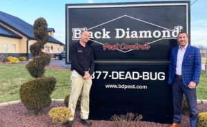 From left, New Elizabethtown Branch Manager Eric Freedland poses with Black Diamond Pest Control CEO Keith Duncan, Jr. in front of the Black Diamond sign. PHOTO: BLACK DIAMOND PEST CONTROL