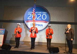 A color guard stands by as Rose Pest Solutions' Russ Ives sings "The Star-Spangled Banner" before lunch is served. PHOTO: PMP STAFF