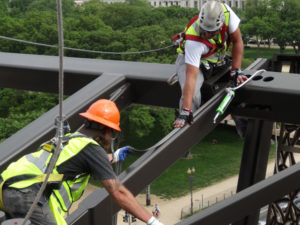 Technicians from Blue Ridge Wildlife & Pest Management lay Bird-Shock electrical track along the National Museum of African American History & Culture in Washington, D.C. PHOTO: BLUE RIDGE WILDLIFE & PEST MANAGEMENT