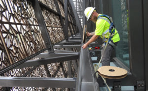 Blue Ridge Wildlife & Pest Management Technician Jason Davis installs Bird-Shock Flex-Track on the roof of the National Museum of African American History & Culture. PHOTO: BLUE RIDGE WILDLIFE & PEST MANAGEMENT