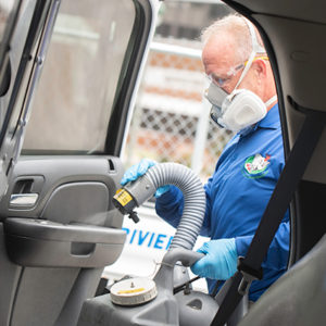 Nozzle Nolen Regional Branch Manager Scott Garver performs the DisMist service on a police cruiser. TRACEY BENSON PHOTOGRAPHY