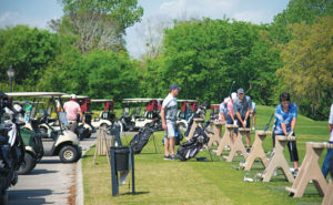 Golfers get in a few practice swings before the event. PHOTO: LOU FERRARO, PARK SOUTH PHOTOGRAPHY