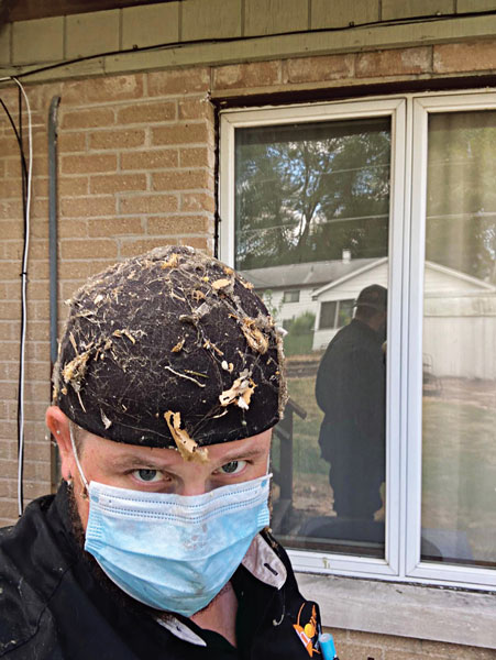 Schopen Pest Solutions’ Observational Biologist Mark Berry proudly emerges from a crawlspace in Wood Dale, Ill., after an inspection. PHOTO: SCHOPEN PEST SOLUTIONS