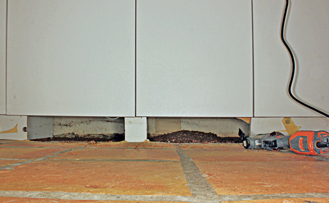 Removing a cabinet kickboard can reveal extensive pet food debris, aka a food source for mice and stored product pests. PHOTO: MARK VANDERWERP