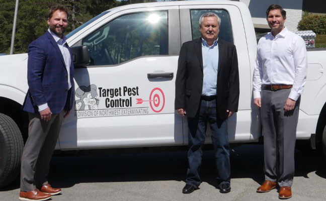 Keith Chandler, center, is flanked by Northwest Co-Presidents Stephen Phillips, left, and Stanford Phillips. PHOTO: NORTHWEST EXTERMINATING