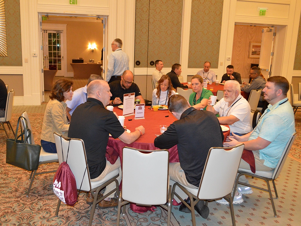 Attendees discuss employee hiring, retention and acknowledgement strategies with Digital Media Specialist RJ Simon. IMAGE: PMP STAFF