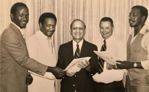 SCHOLARSHIP WINNERS: The first FAMU and Black students to receive the Florida Pest Control Association Scholarship (circa 1978) are, from left, student John Dukes III (currently founder and owner of Dr. Buggs Exterminators, Gainesville, Fla.; then-FAMU President Dr. Walter Washington; Reuben Capelouto, founder of Tallahassee, Fla.-based Capelouto Pest Control; Dr. Bill Peters, who began the FAMU entomology program and for whom the Field Day event is named; and student John Houston. (PHOTO: JOHN DUKES III)