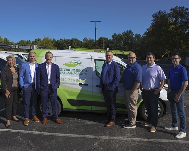 EPM and Anticimex leaders in front of an EPM vehicle
