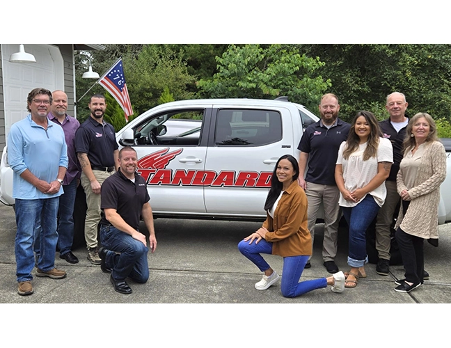 Group of people posed around Standard Pest Control truck