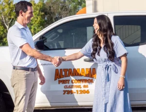 Yates-Astro and Altamaha leaders shaking hands by a truck.